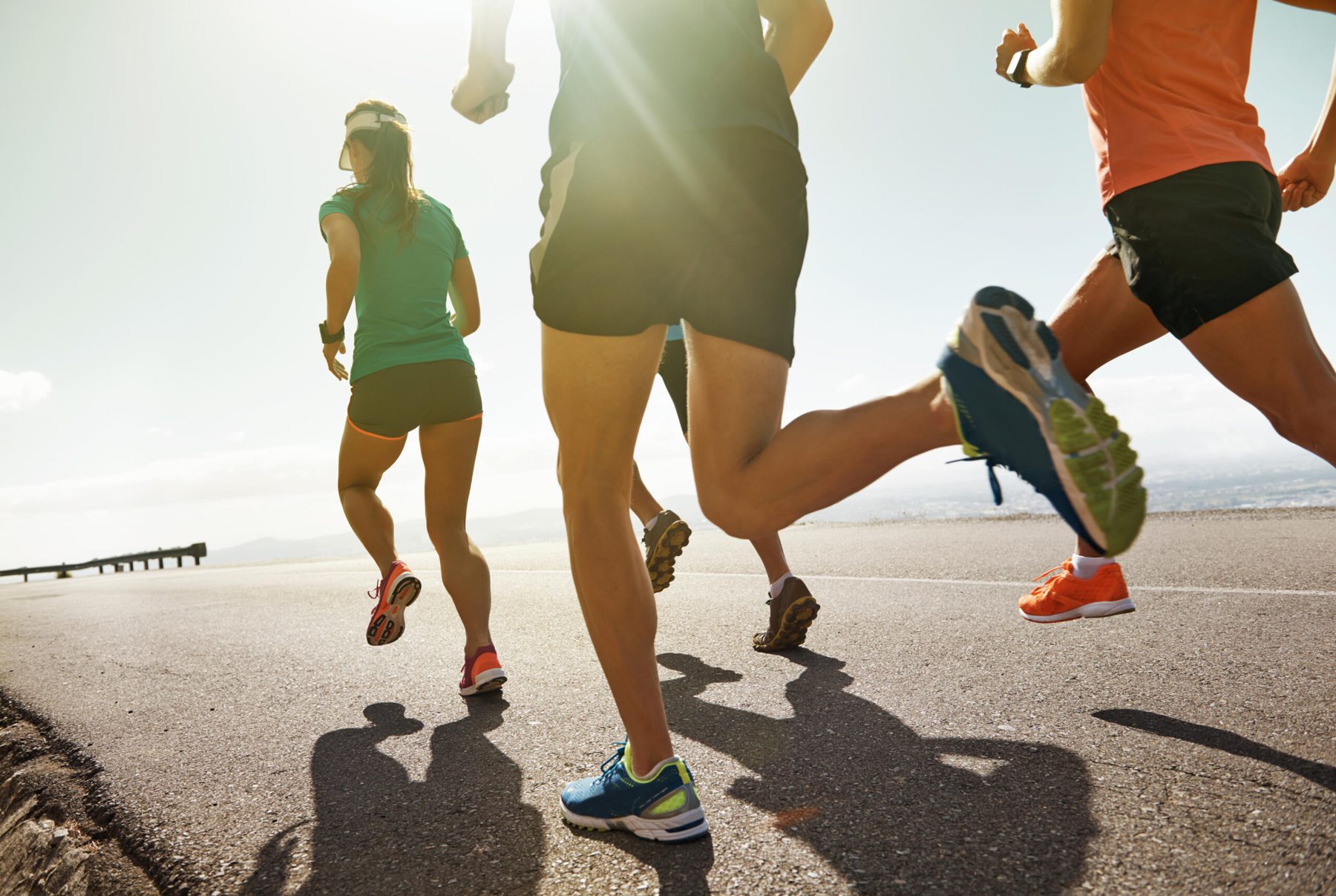 Runners on an open road at sunrise